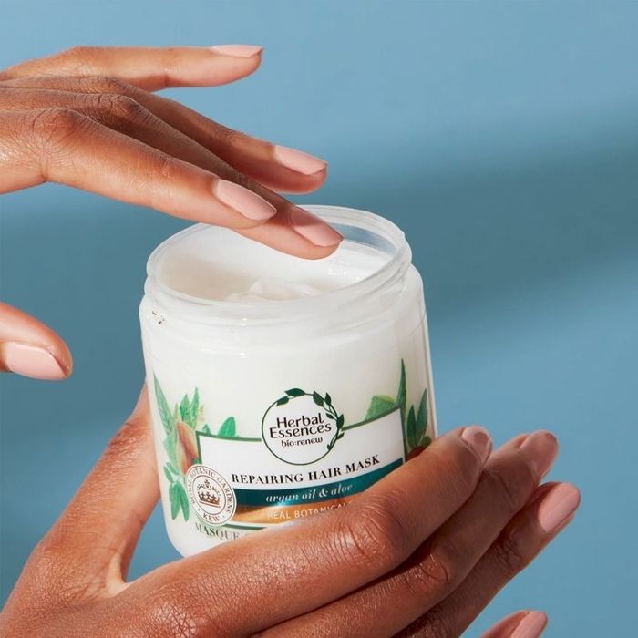 Model opening the hair mask
