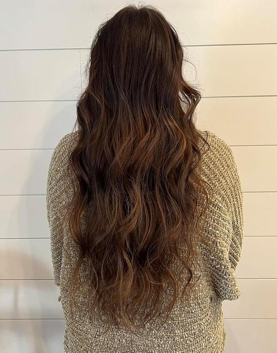 reviewer with wavy hair viewed from behind