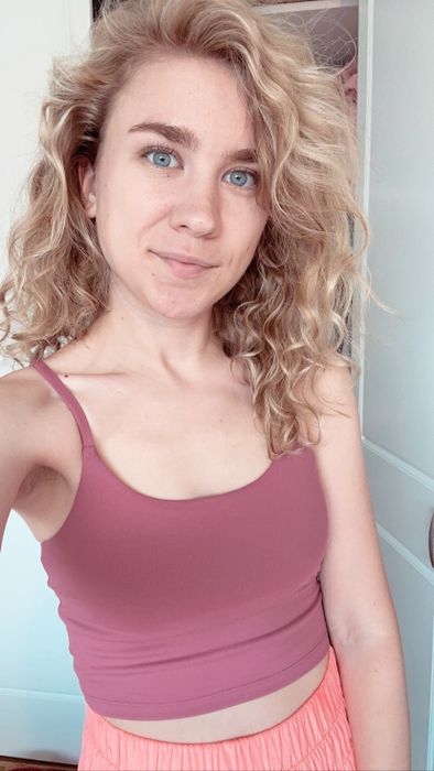 A Mytour editor is seen wearing a pink strappy crop top.
