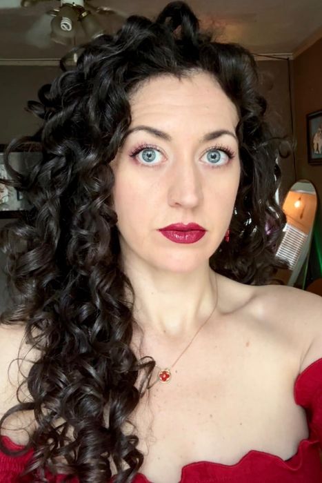 A reviewer with glossy, curly, brown hair