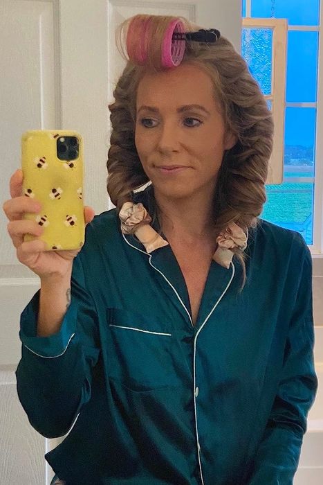 A reviewer with the curling set in their hair before going to bed