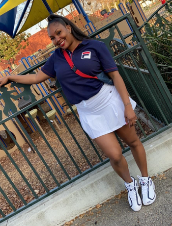 A reviewer is seen wearing a high-waisted white skort.