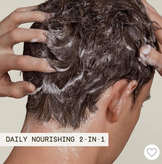 A person applying shampoo to their hair, with the text "Daily Nourishing 2-in-1" displayed below