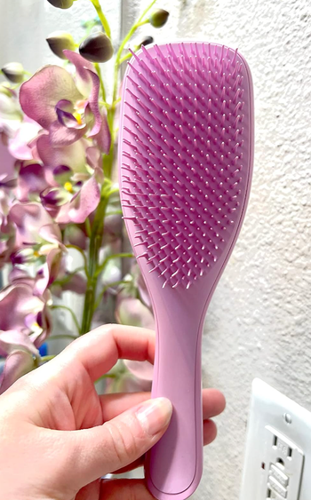 reviewer holding the pink brush