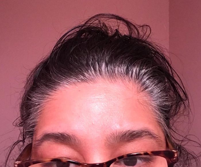 A reviewer with gray roots and dark brown hair