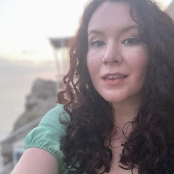 writer with naturally curly hair