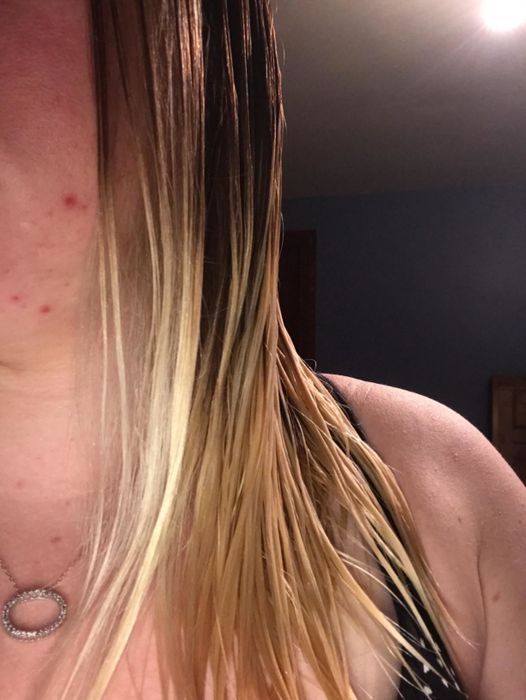 The identical reviewer displaying smooth, detangled hair post-brush usage