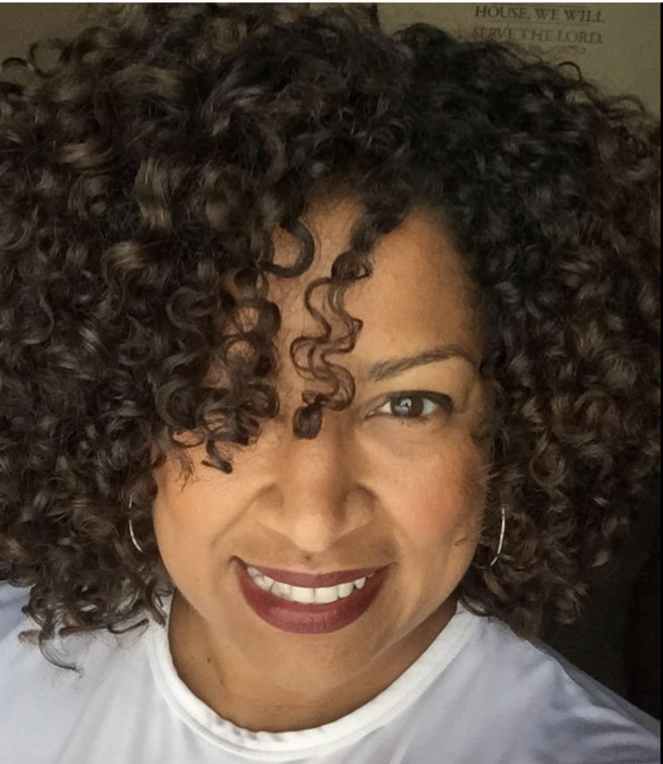 a reviewer showcasing their styled curly hair after using the diffuser