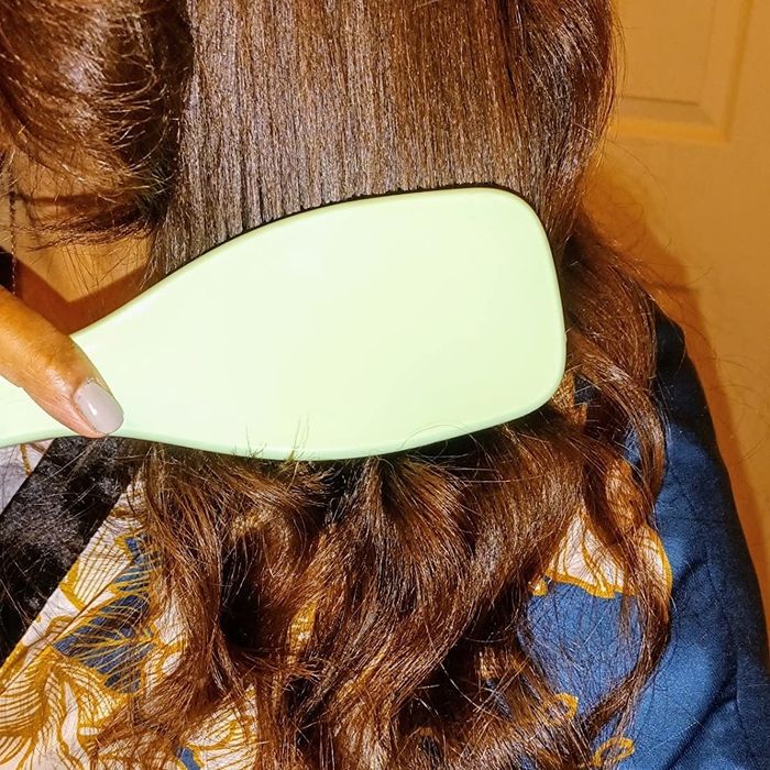 A reviewer using the brush on their dry 3B/3C type hair