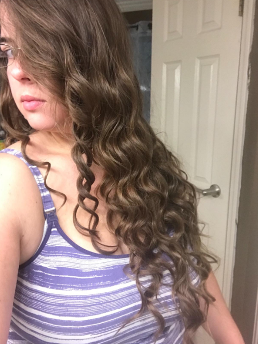 The same reviewer showcasing their fully curled hair