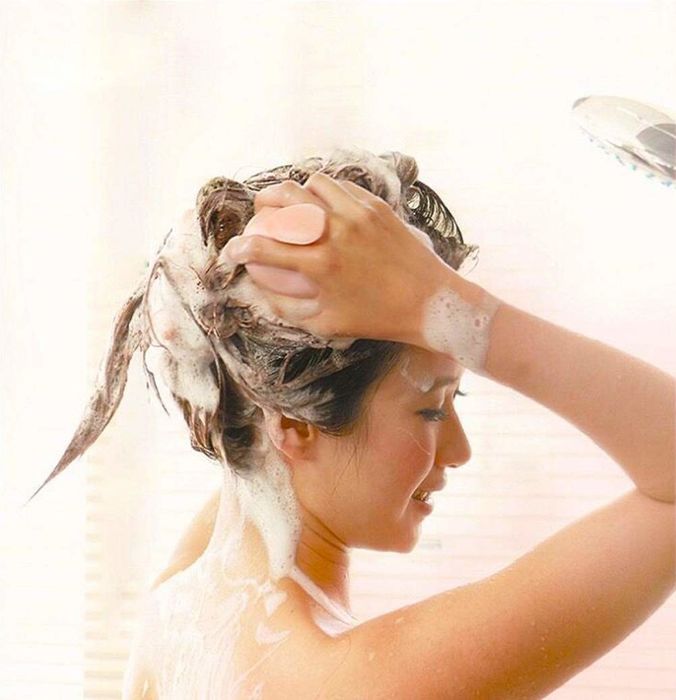 A model demonstrating the use of the brush during a shower