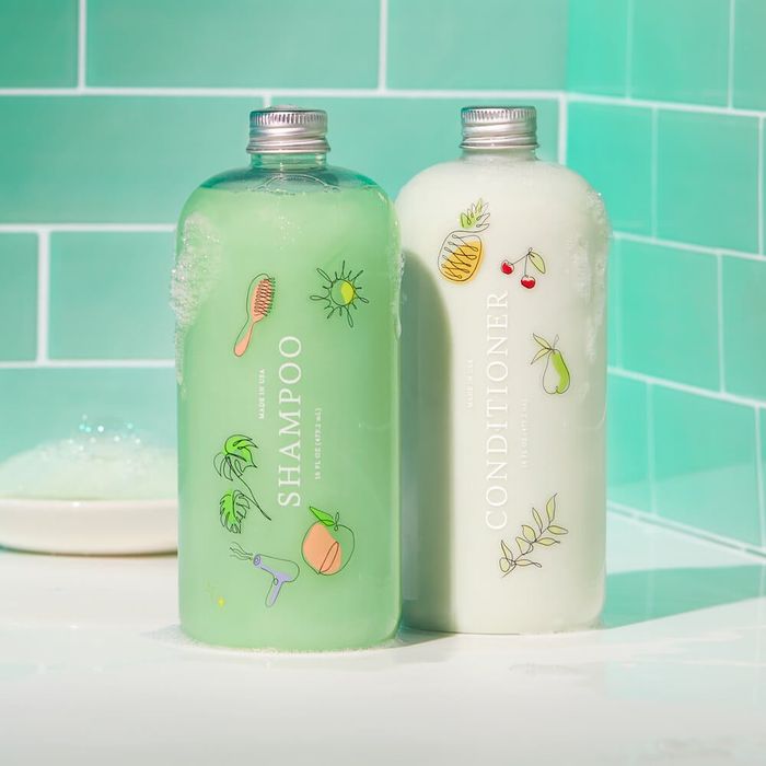Bottle of green shampoo paired with white conditioner
