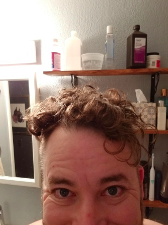 A reviewer showcasing their naturally curly hair