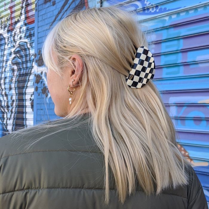 Mytour editor wearing a black-and-white checkered claw clip