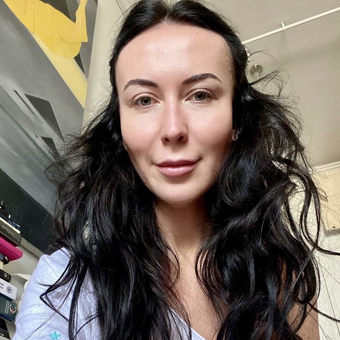 Another reviewer showcasing one side of their hair curled and the other side natural, midway through curling