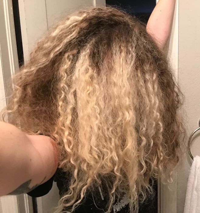 A before photo of the reviewer’s hair looking dry with less-defined curls