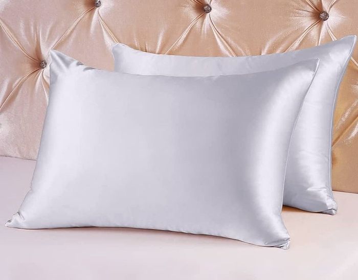 Two pillows adorned with silk pillowcases