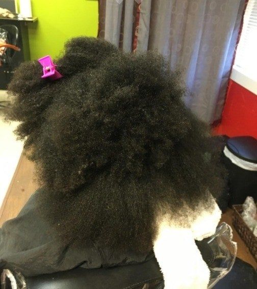 A reviewer with thick, voluminous curls