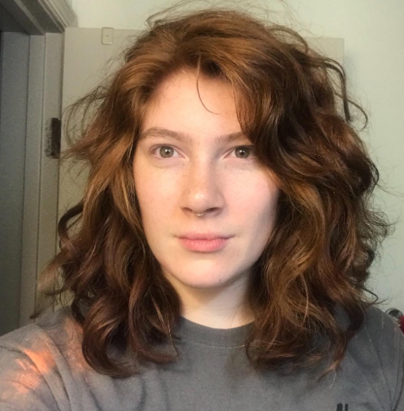 reviewer with soft, natural-looking waves in their hair