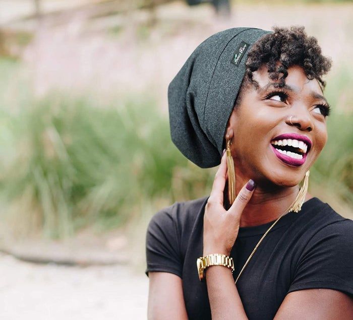 a model showcasing the cotton cap in dark gray