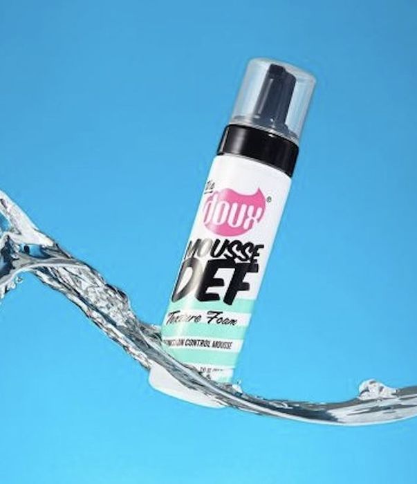 A bottle of hair mousse for styling.
