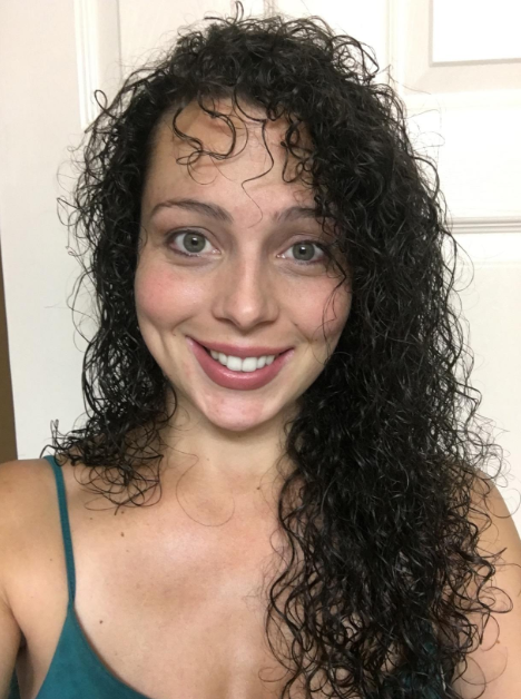 A reviewer displaying their naturally curly hair