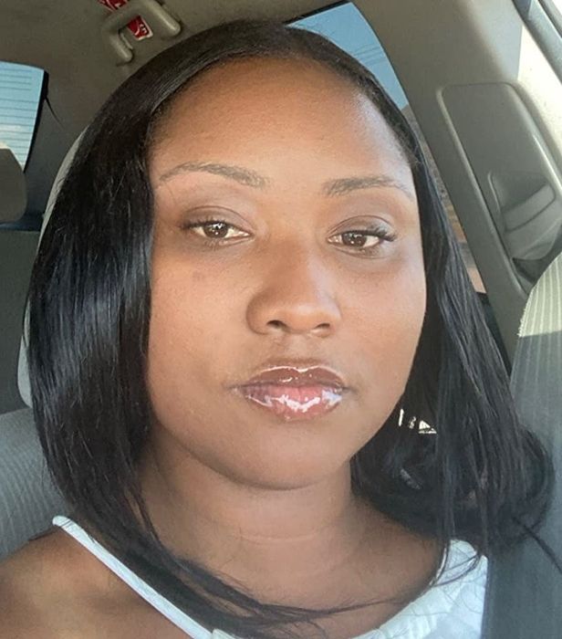 A reviewer with sleek, smoothed-down hair after using the hair stick