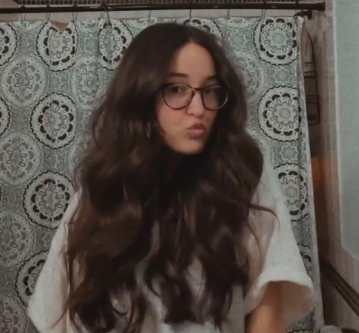 a reviewer showcasing their volumized hair