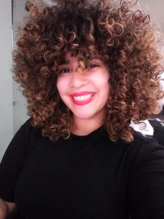 reviewer with stunning, voluminous coils and curls achieved using the cream