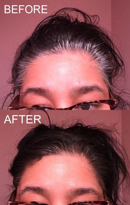 A reviewer with gray roots and dark brown hair demonstrates how the spray effectively conceals their grays