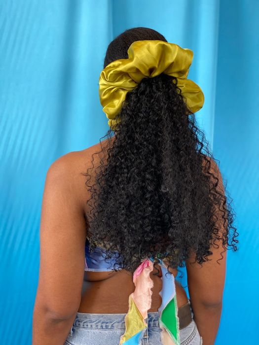 A photo of the back of a model wearing the chartreuse scrunchie
