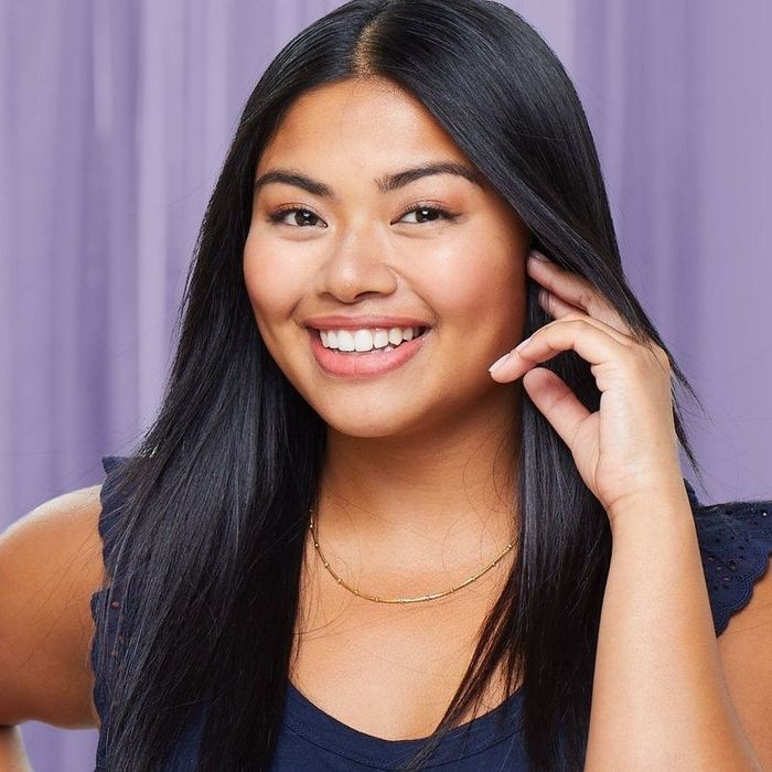 A person proudly showcasing their sleek, straight hair.