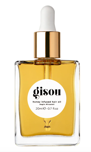 the bottle of honey-infused hair oil