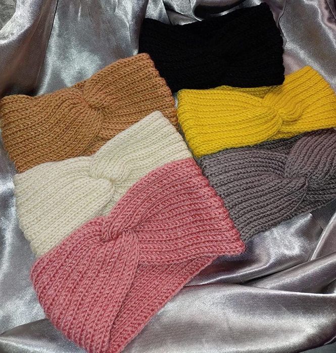 A photo of six headbands in tan, white, pink, black, yellow, and gray