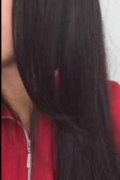 The same reviewer displaying their hair with significantly reduced frizz