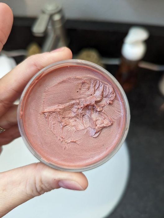 A reviewer holding the blush product