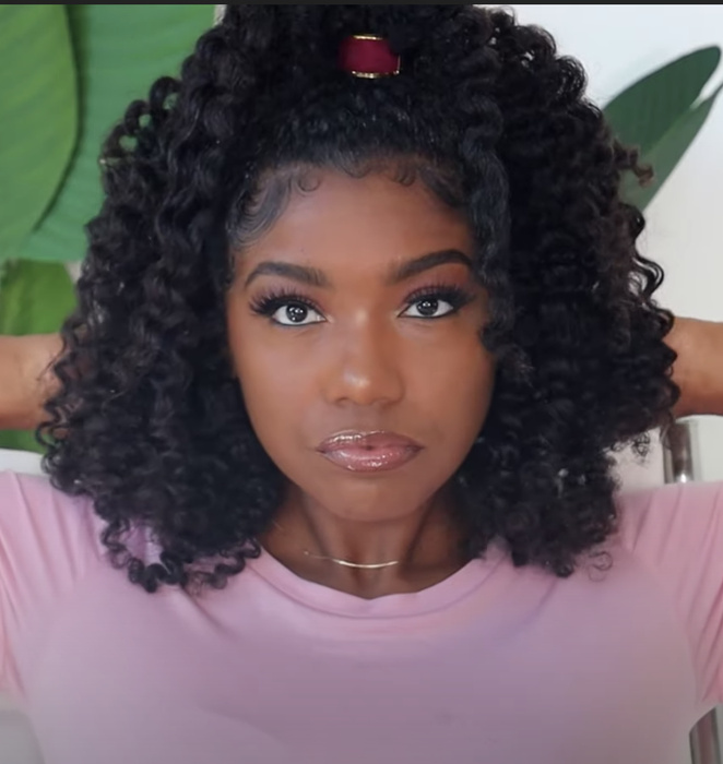 A model showcasing their twist-out hairstyle after using the product