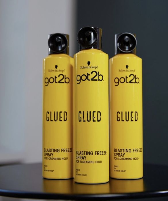 A set of three hairspray cans, each designed to provide long-lasting hold.