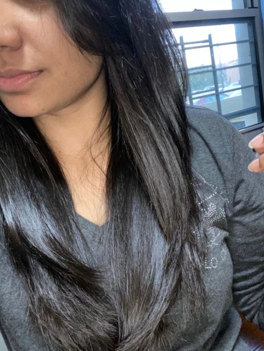 Reviewer with wavy hair appearing soft and shiny after using the product