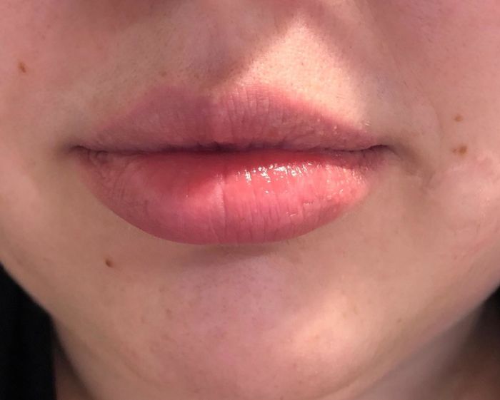 Close-up of the reviewer wearing the product on their lips