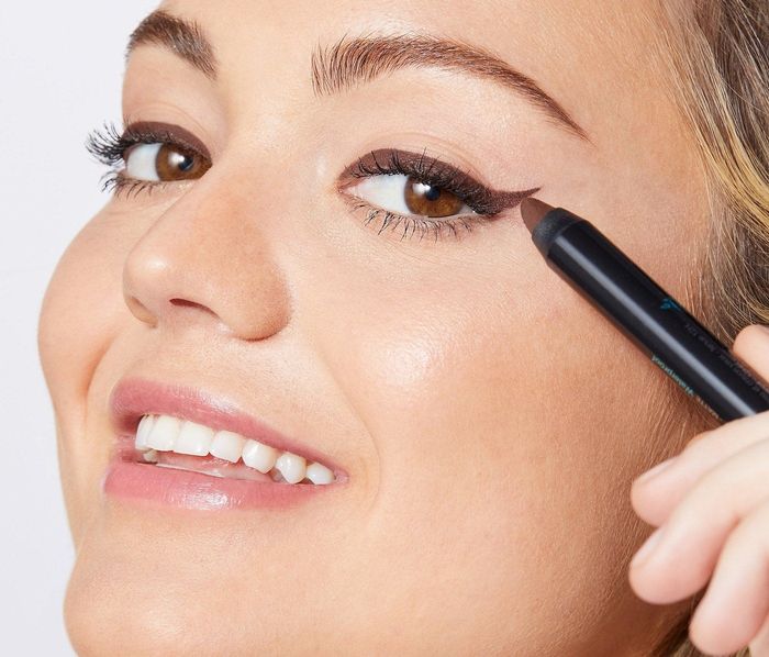 a model applying the brown multi-stick for a subtle, everyday look