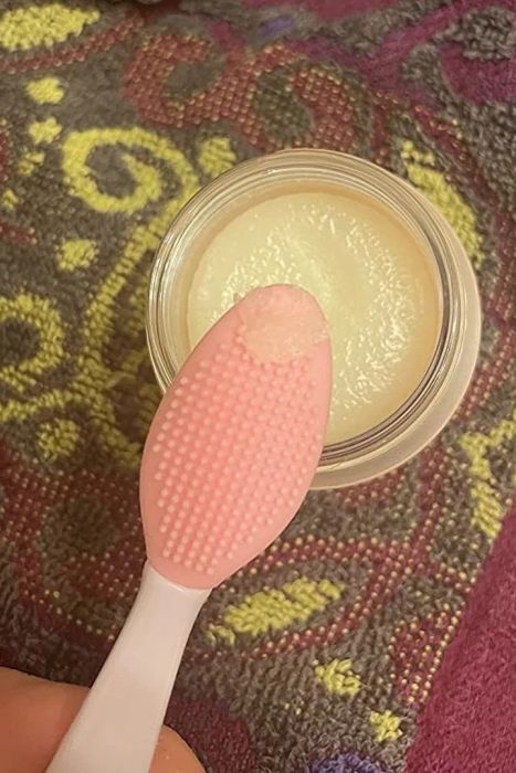A small amount of the lip scrub on an exfoliating brush.