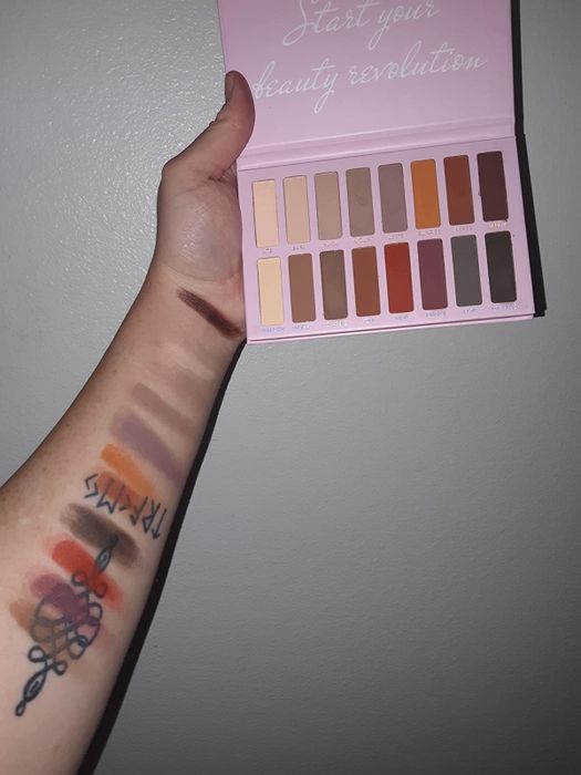A reviewer holding the nude matte palette.