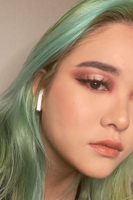 A reviewer showcasing the concealer applied to their skin