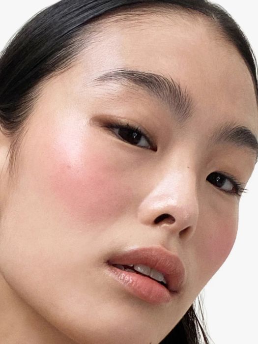 a model wearing the Cloud Paint blush in the shade