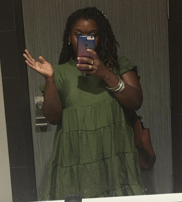 reviewer in an olive green dress