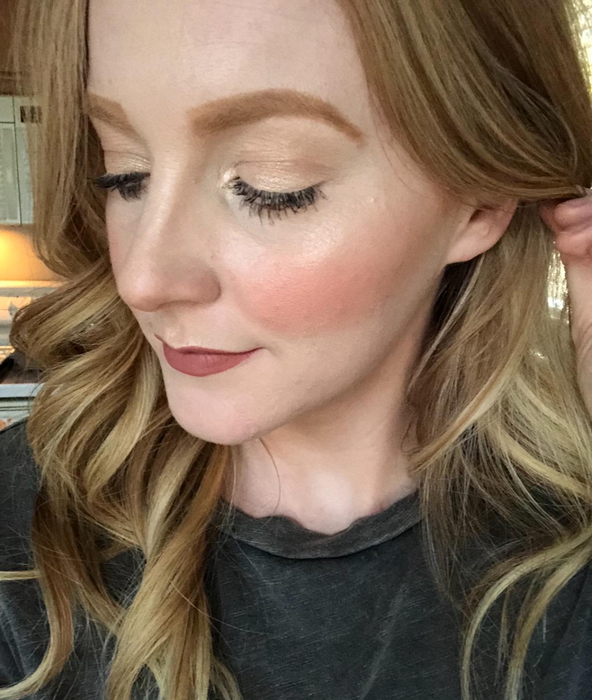 a reviewer photo of them wearing the bronzer on their face and brows