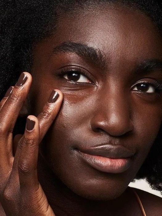 a model applying the concealer to their face for a flawless finish