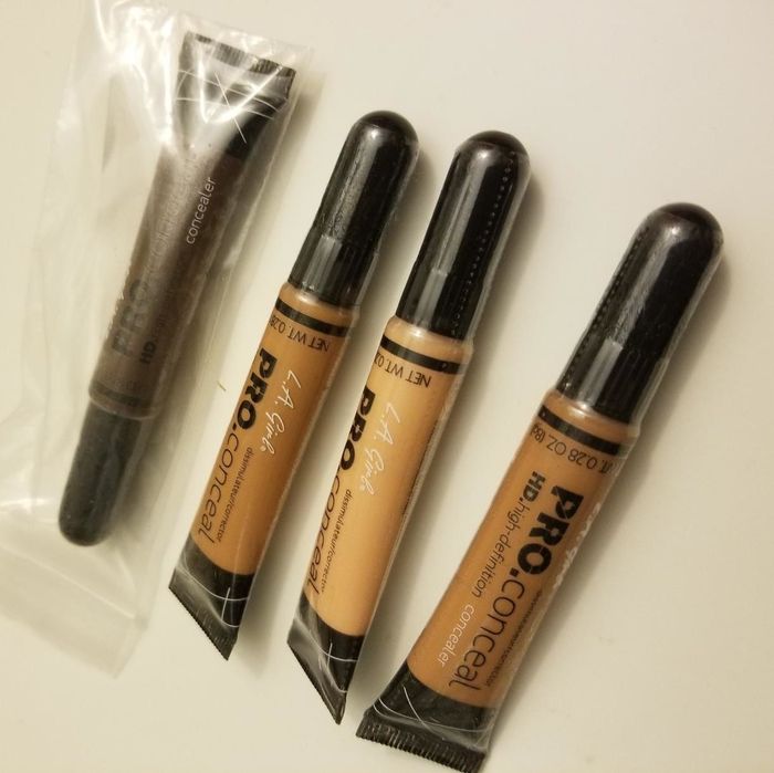 A reviewer displaying an image of four different concealers