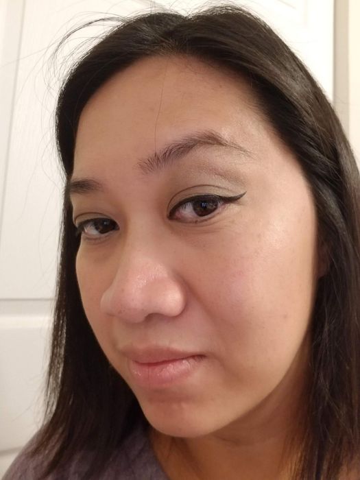 A reviewer sporting flawless cat-eye eyeliner applied with the stamp.